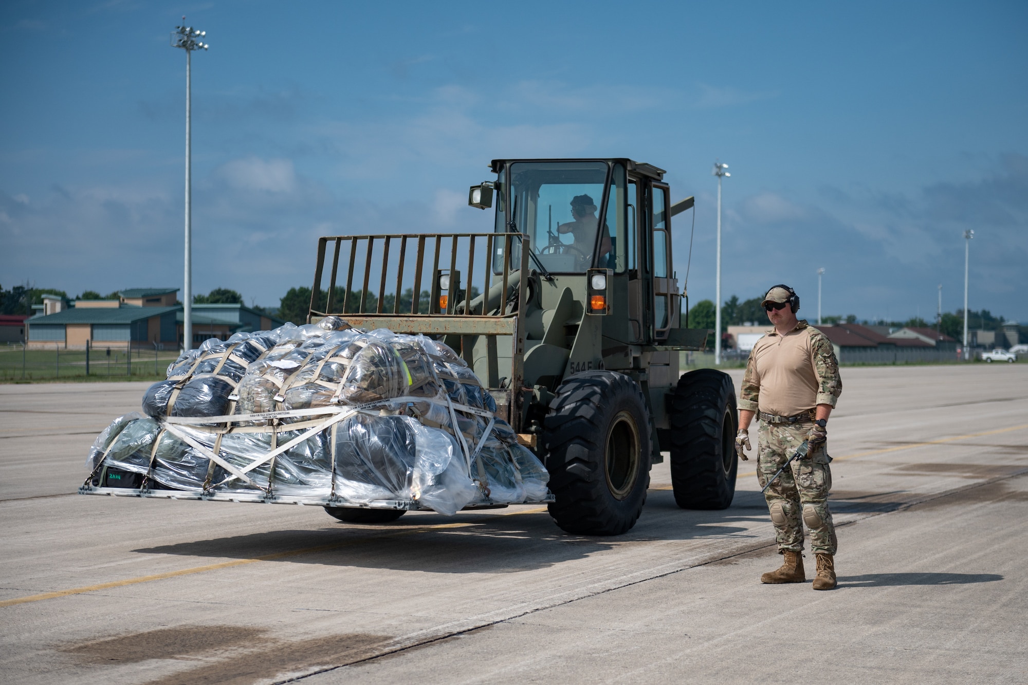 A U.S. Air Force Airman from the Kentucky Air National Guard’s 123rd Contingency Response Group transports cargo at Volk Field Combat Readiness Training Center, Wis., Aug. 21, 2026, during Exercise Patriot 26. The Air National Guard-hosted exercise brings together approximately 1,000 Airmen and Soldiers from National Guard units across 35 states, along with federal, state and local agencies, to enhance domestic response readiness and interagency coordination during large-scale emergencies. (U.S. Air National Guard photo by Senior Airman Angelee Barnett)