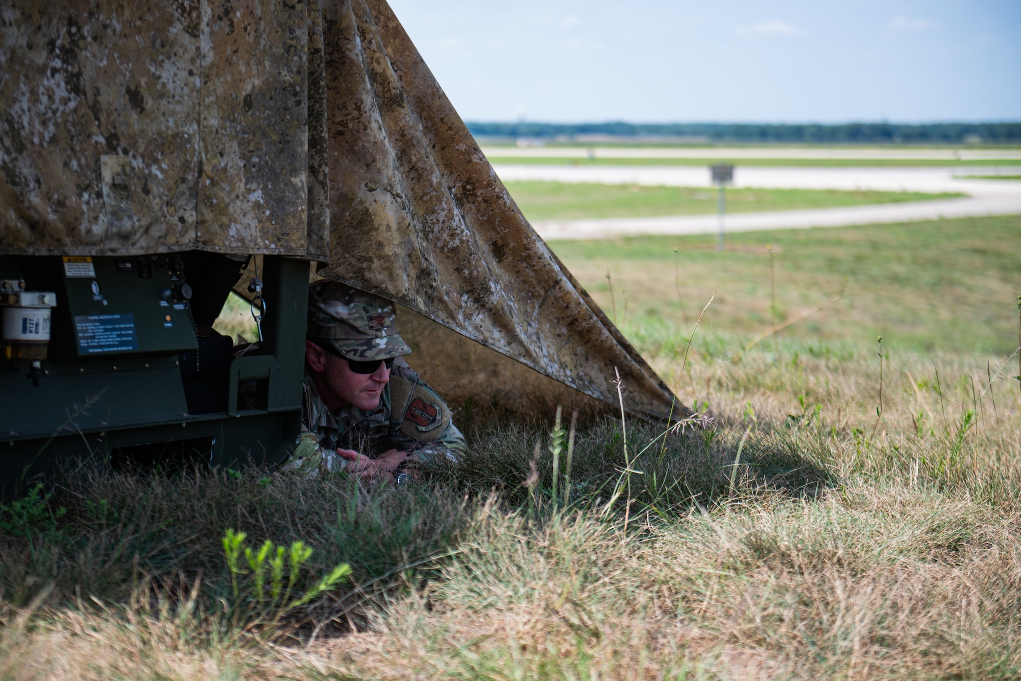 U.S. Air Force Col. Aaron Zamora, commander of the Kentucky Air National Guard’s 123rd Contingency Response Group, seeks cover during a simulated attack at Volk Field Combat Readiness Training Center, Wis., Aug. 25, 2026, during exercise Patriot 26. The Air National Guard-hosted exercise brings together approximately 1,000 Airmen and Soldiers from National Guard units across 35 states, along with federal, state and local agencies, to enhance domestic response readiness and interagency coordination during large-scale emergencies. (U.S. Air National Guard photo by Senior Airman Angelee Barnett)