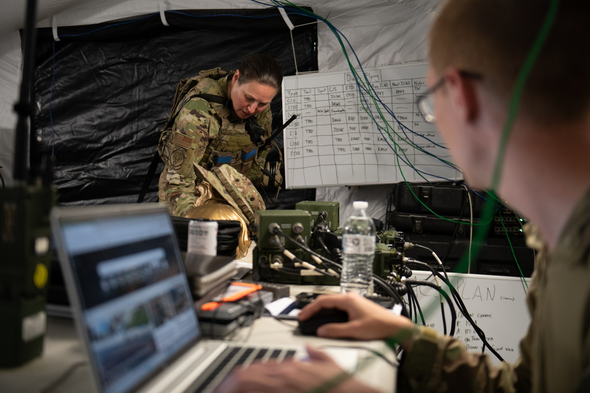 U.S. Air Force Tech. Sgt. Megan Zimmerman, left, a loadmaster, and Staff Sgt. Nicholas Chapman, a command-and-control operations specialist — both with the Kentucky Air National Guard’s 123rd Contingency Response Group — discuss aircraft arrivals at Volk Field Combat Readiness Training Center, Wis., Aug. 26, 2026, during exercise Patriot 26. The Air National Guard-hosted exercise brings together approximately 1,000 Airmen and Soldiers from National Guard units across 35 states, along with federal, state and local agencies, to enhance domestic response readiness and interagency coordination during large-scale emergencies. (U.S. Air National Guard photo by Senior Airman Angelee Barnett)