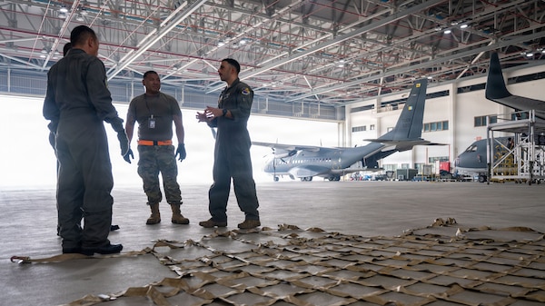 U.S. Air Force Tech. Sgt. Jamal Miqbel, right, 79th Rescue Squadron HC-130J loadmaster, explains cargo loading procedures during a hands-on demonstration at Rimba Air Base, Brunei Darussalam, Aug. 31, 2026.