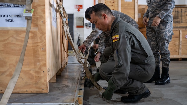 A member of the Royal Brunei Air Force attaches a hook during cargo loading training as part of PACIFIC ANGEL 26-1at Rimba Air Force Base, Brunei Darussalam Aug. 31, 2026.