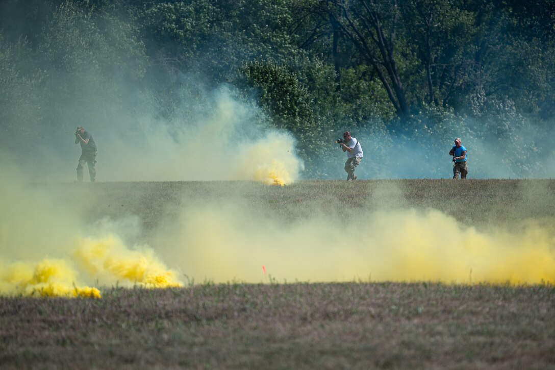 Simulated opposing forces charge through smoke at Volk Field Combat Readiness Training Center, Wis., Aug. 26, 2026, during exercise Patriot 26. The Air National Guard-hosted exercise brings together approximately 1,000 Airmen and Soldiers from National Guard units across 35 states, along with federal, state and local agencies, to enhance domestic response readiness and interagency coordination during large-scale emergencies. (U.S. Air National Guard photo by Senior Airman Angelee Barnett)