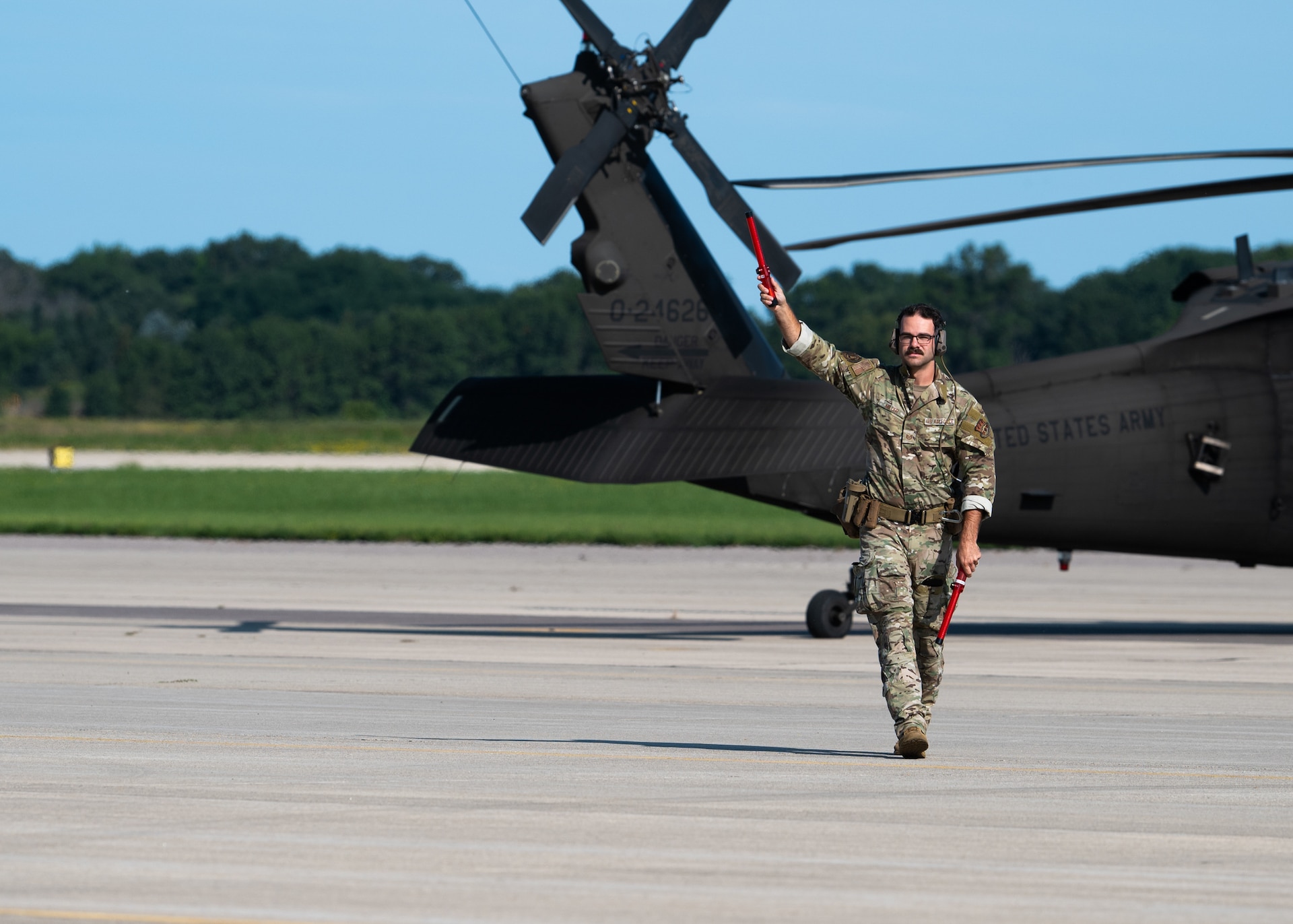 U.S. Air Force Tech. Sgt. Nicholas Miller, a crew chief with the Kentucky Air National Guard’s 123rd Contingency Response Group, directs aircraft at Volk Field Combat Readiness Training Center, Wis., Aug. 24, 2026, during exercise Patriot 26. The Air National Guard-hosted exercise brings together approximately 1,000 Airmen and Soldiers from National Guard units across 35 states, along with federal, state and local agencies, to enhance domestic response readiness and interagency coordination during large-scale emergencies. (U.S. Air National Guard photo by Senior Airman Angelee Barnett)