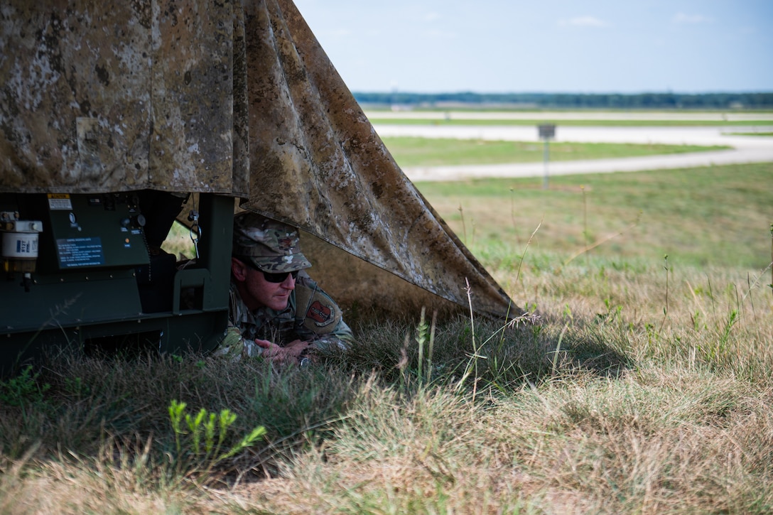 U.S. Air Force Col. Aaron Zamora, commander of the Kentucky Air National Guard’s 123rd Contingency Response Group, seeks cover during a simulated attack at Volk Field Combat Readiness Training Center, Wis., Aug. 25, 2026, during exercise Patriot 26. The Air National Guard-hosted exercise brings together approximately 1,000 Airmen and Soldiers from National Guard units across 35 states, along with federal, state and local agencies, to enhance domestic response readiness and interagency coordination during large-scale emergencies. (U.S. Air National Guard photo by Senior Airman Angelee Barnett)