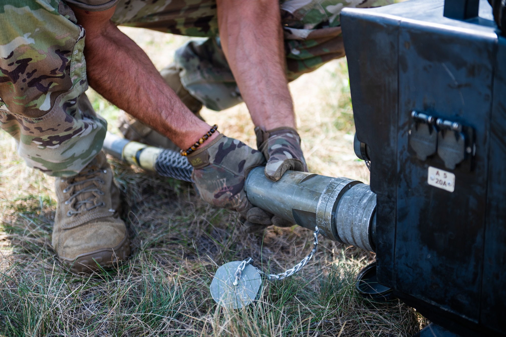 A U.S. Air Force Airman from the Kentucky Air National Guard’s 123rd Contingency Response Group connects a cable to a generator during camp setup for exercise Patriot 2026 at Volk Field Combat Readiness Training Center, Wis., Aug. 20, 2026. Patriot 26, an Air National Guard-hosted exercise brings together approximately 1,000 Airmen and Soldiers from National Guard units across 35 states, along with federal, state and local agencies, to enhance domestic response readiness and interagency coordination during large-scale emergencies. (U.S. Air National Guard photo by Senior Airman Angelee Barnett)