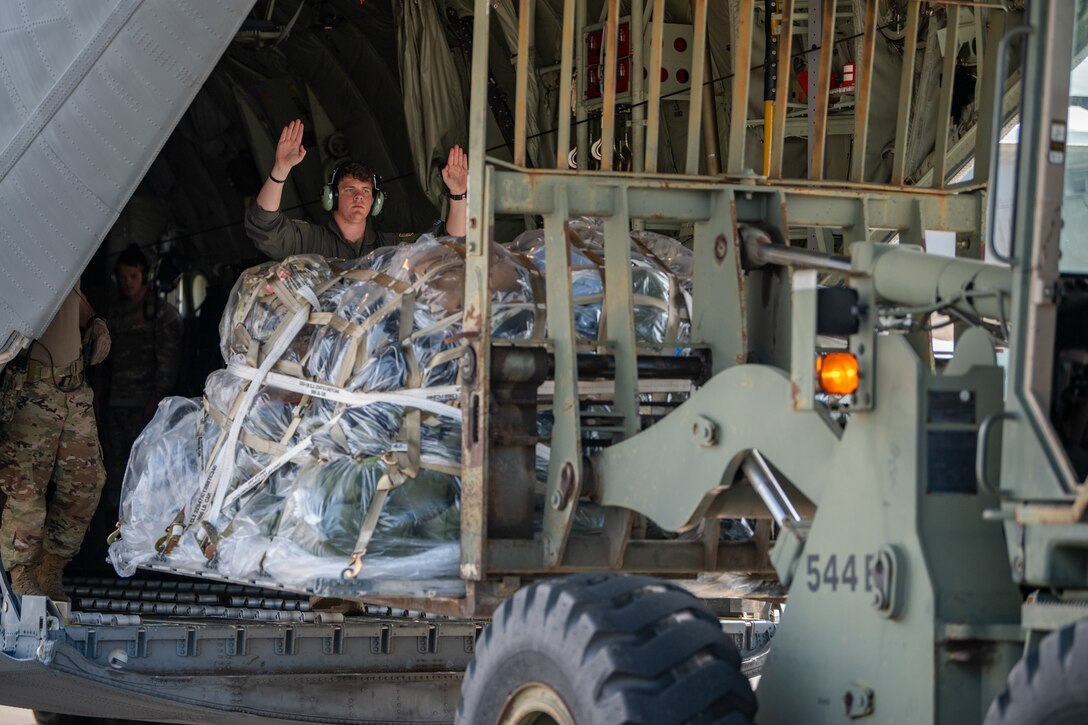 U.S. Air Force Airman 1st Class Kyle Brentzel, a loadmaster with the Kentucky Air National Guard’s 123rd Airlift Wing, guides a forklift unloading cargo at Volk Field Combat Readiness Training Center, Wis., Aug. 21, 2026, during Exercise Patriot 26. The Air National Guard-hosted exercise brings together approximately 1,000 Airmen and Soldiers from National Guard units across 35 states, along with federal, state and local agencies, to enhance domestic response readiness and interagency coordination during large-scale emergencies. (U.S. Air National Guard photo by Senior Airman Angelee Barnett)