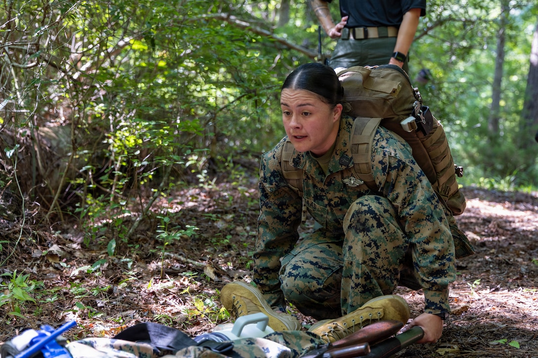 U.S. Navy Hospital Corpsman Third Class Vanessa Saad, a corpsman with 1st Battalion, 8th Marines, 6th Marine Regiment, prepares to lift a litter with a simulated casualty during an Expeditionary Operations Training Group mass casualty course, at Marine Corps Base Camp Lejeune, North Carolina, Sept. 1, 2026. The course was designed to train 26th Marine Expeditionary Unit Health Service Support personnel in order to prepare the unit for potential mass casualty response while conducting operations abroad. (U.S. Marine Corps photo by Cpl. Channah Chilton)