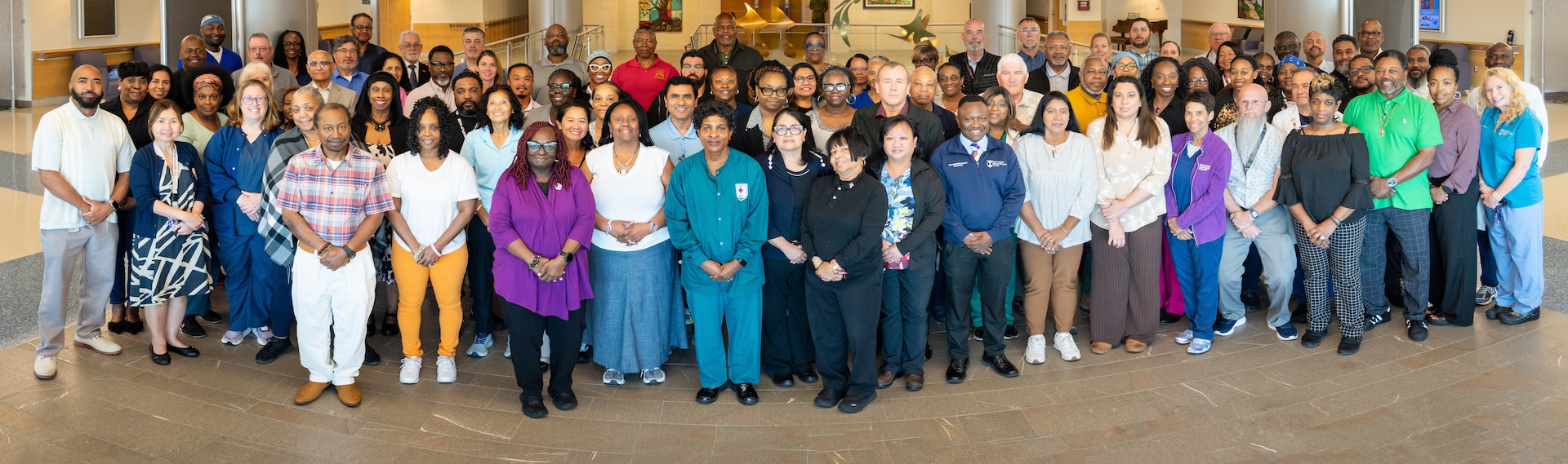 Many of ATAMMC’s original staff, “plank owners”, pose for a photo honoring 15 years of a Culture of Excellence.