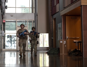 U.S. Air Force Tech. Sgt. Andrey Shimko and Airman Iveth Saligan, 133rd Security Forces Squadron, search and secure a building in St. Paul, Minn., July 20, 2026.