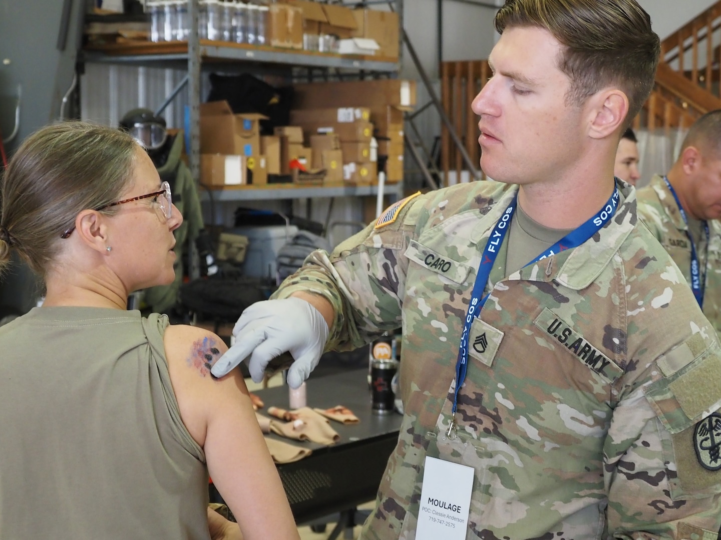 Staff Sgt. Ian Caro, a 68w Combat Medic assigned to the Evans Army Community Hospital Education Department, applies moulage to an exercise casualty volunteer during a full-scale Mass Casualty exercise simulating a commercial aircraft crash at the Colorado Springs Airport Aug. 19, 2026.