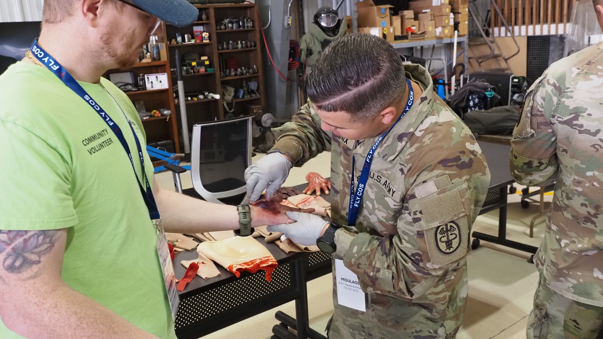 Staff Sgt. Dezman Phoenix, a 68w Combat Medic assigned to the Evans Army Community Hospital Education Department, applies moulage to an exercise casualty volunteer during a full-scale Mass Casualty exercise simulating a commercial aircraft crash at the Colorado Springs Airport Aug. 19, 2026.