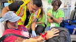Private 1st Class Oziel Lara, a 68w Combat Medic assigned to the Evans Army Community Hospital Department of Emergency Services, checks vita signs of an exercise casualty volunteer during a full-scale Mass Casualty exercise simulating a commercial aircraft crash at the Colorado Springs Airport Aug. 19, 2026.