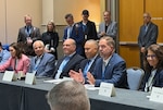 People talk while seated around a table.