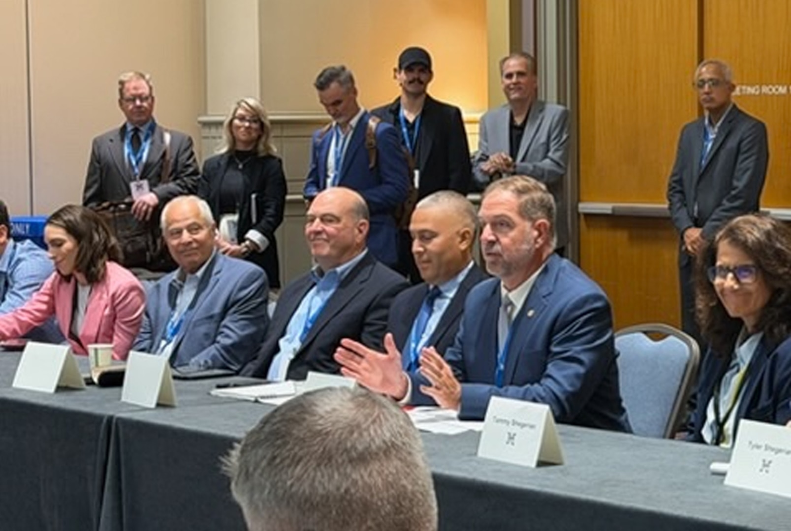 People talk while seated around a table.