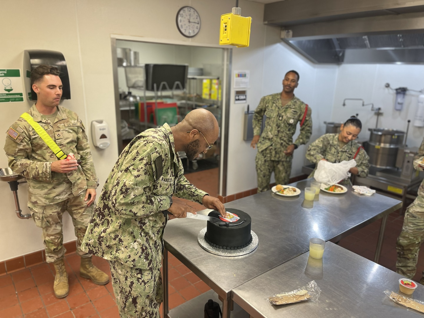 Navy Petty Officer 1st Class (SW/AW) Steven Randolph cuts a cake to celebrate his birthday in the Medical Education and Training Campus (METC) Nutrition and Diet Therapy course kitchen laboratory on Joint Base San Antonio-Fort Sam Houston, Texas June 30, 2026. Randolph and two other Navy culinary specialists have successfully completed a pilot audit of the Army’s 68M Nutrition Care Specialist course at METC. This effort marks a significant step toward bridging a critical gap in nutrition support for Sailors and enhancing overall fleet readiness and performance.