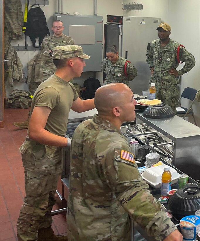 Navy Culinary Specialists and Army students work together during a practical application session in the Army's Nutrition and Diet Therapy course at the Medical Education and Training Campus on Joint Base San Antonio-Fort Sam Houston, Texas. Three Navy Culinary Specialists have successfully completed a pilot audit of the Army’s 68M Nutrition Care Specialist course, a significant step toward bridging a critical gap in nutrition support for Sailors and enhancing overall fleet readiness and performance.