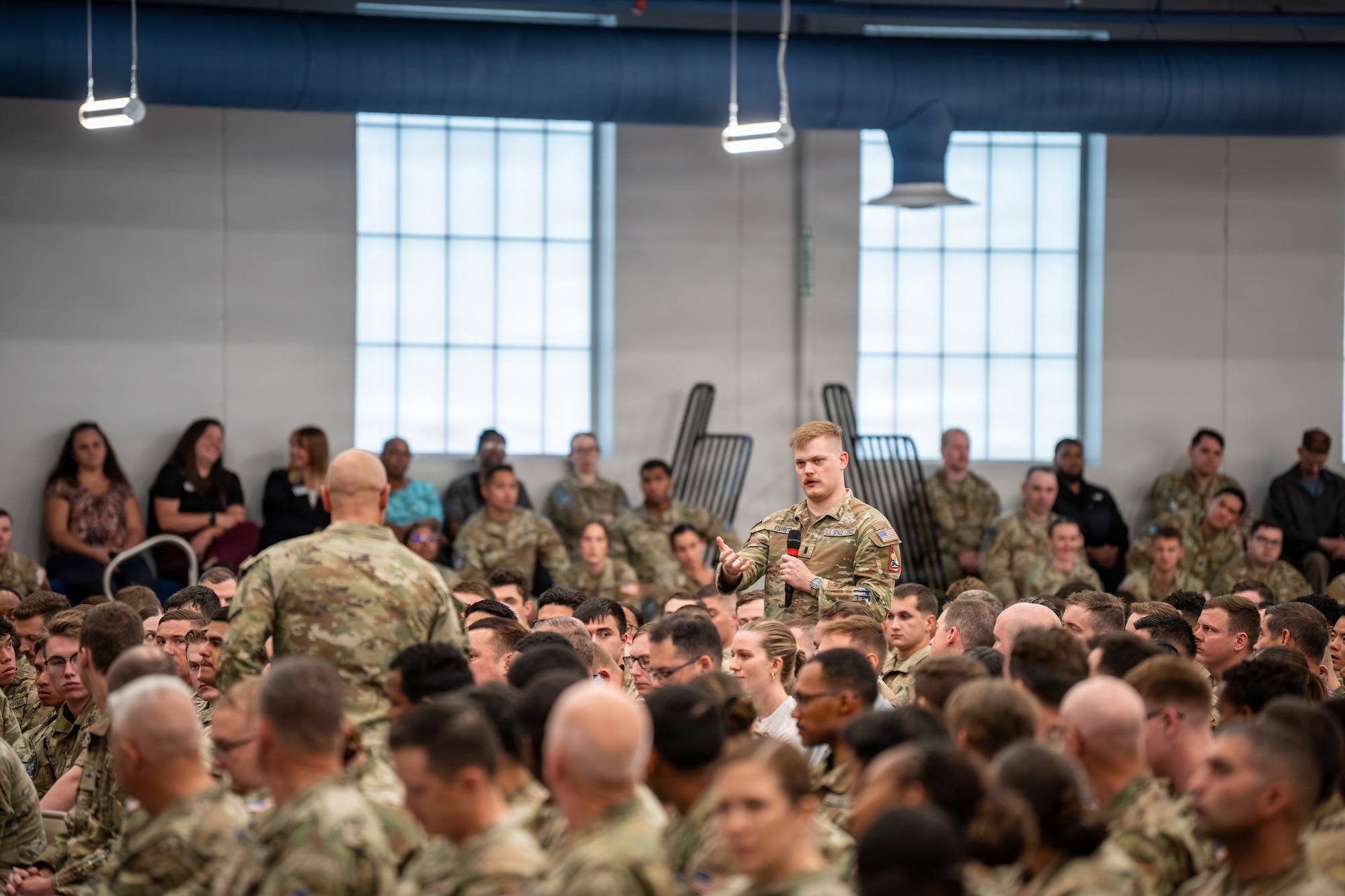 A U.S. Space Forces-Space Guardian asks Chief Master Sgt. of the Space Force John Bentivegna a question during an all-call at Schriever Space Force Base.