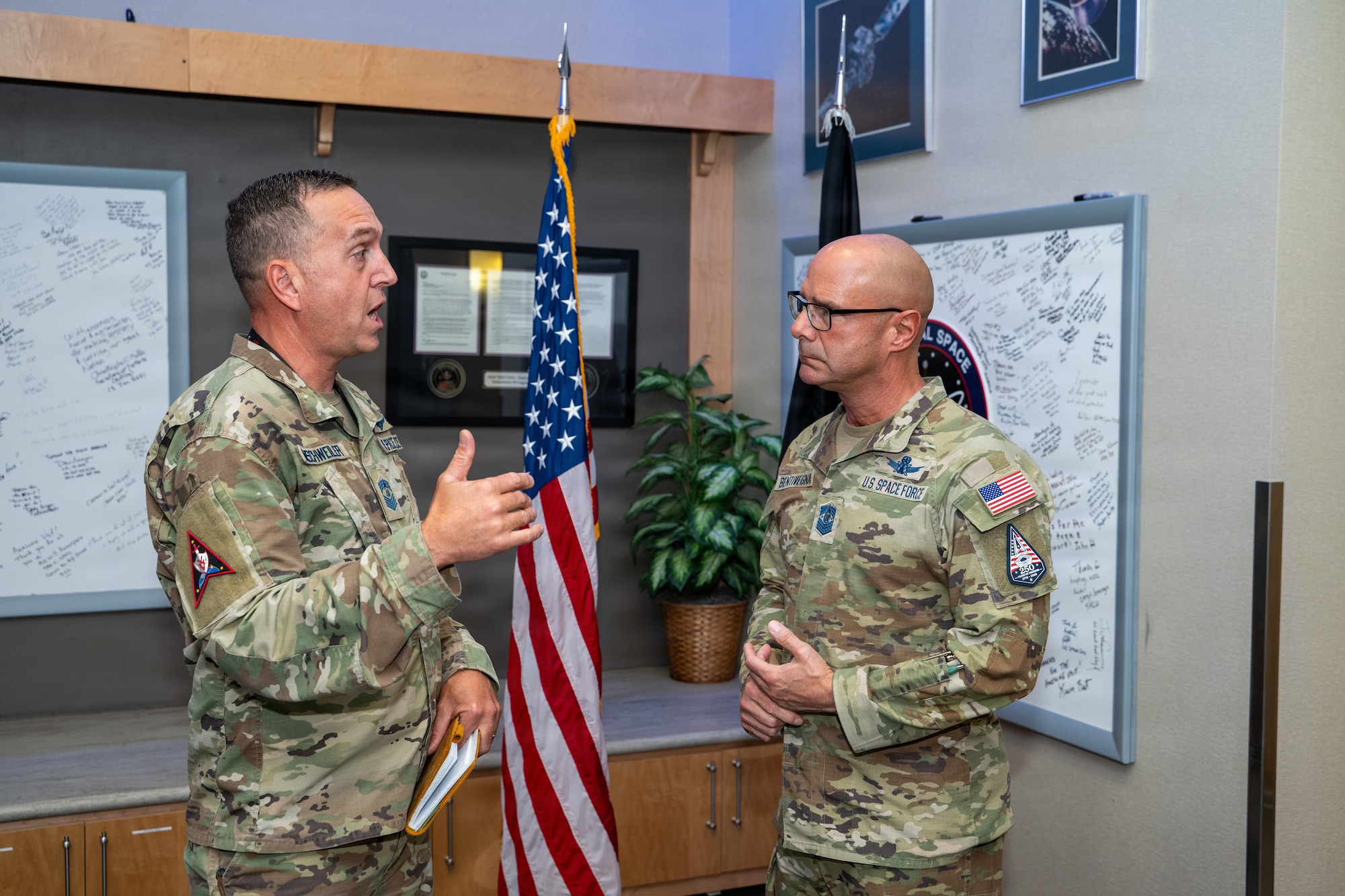 Chief Master Sgt. of the Space Force John Bentivegna, right, speaks with Chief Master Sgt. Matthew Imschweiler, left.