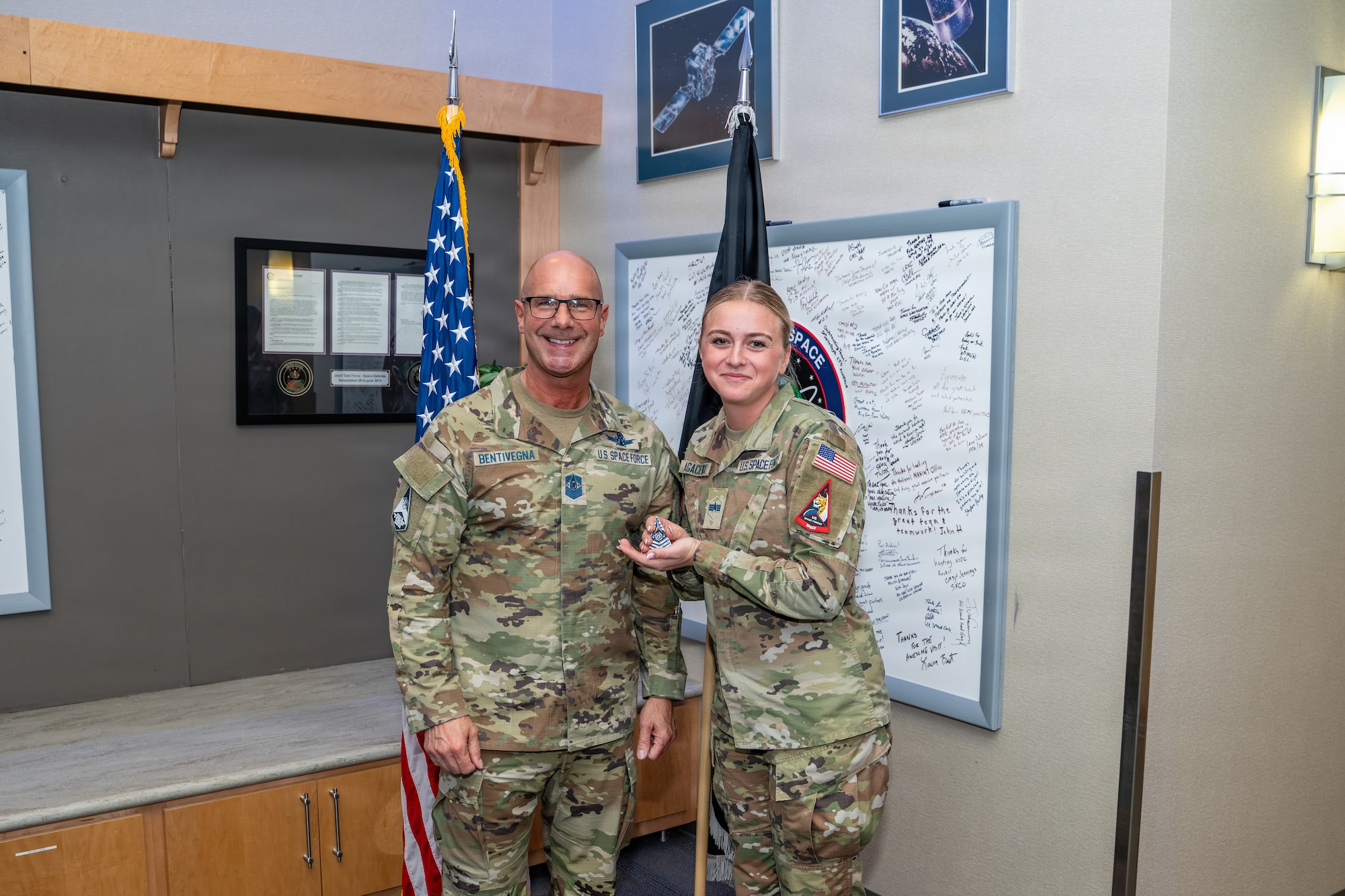 Chief Master Sgt. of the Space Force John Bentivegna, left, poses for a photo with Spc. 4 Ashlynn Agaciewski, right.