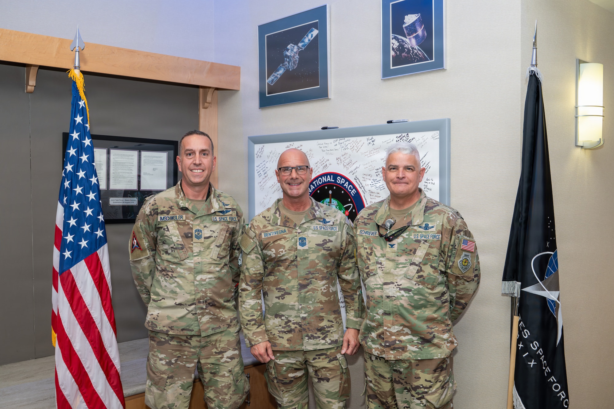 Chief Master Sgt. of the Space Force John Bentivegna, center, poses for a photo with Chief Master Sgt. Matthew Imschweiler, Space Delta 15 senior enlisted leader and National Space Defense Center senior enlisted advisor, left, and U.S. Space Force Col. Michael Schriever, NSDC deputy director, right.