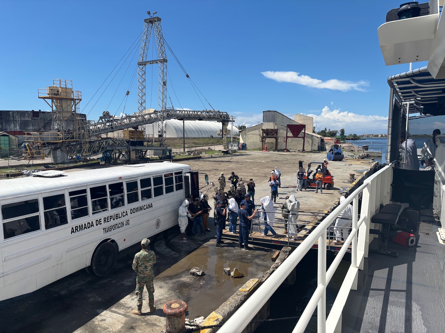Crewmembers aboard the Coast Guard Cutter Joseph Doyle repatriate and transfer 75 migrants to Dominican Republic Navy authorities in San Pedro de Macorís, Dominican Republic, Sept. 4, 2026. The crew interdicted the group on Sept. 2, 2026, after intercepting a grossly overloaded makeshift boat in the Mona Passage off the coast of Puerto Rico. (U.S. Coast Guard photo)