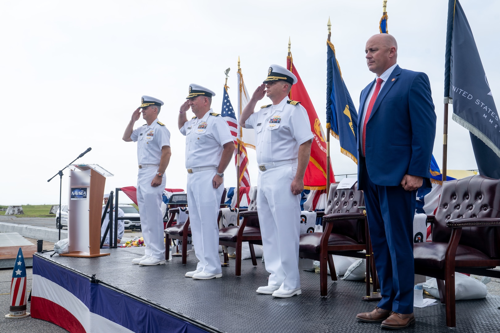 From left to right, U.S. Navy Rear Adm. Peter D. Small, the acting commander for Naval Sea Systems Command, Capt. Joseph J. Oravec, the outgoing commanding officer for Naval Surface Warfare Center Dahlgren Division, Capt. Jason A. Flanagan, the incoming commanding officer, and Pastor Thomas Preston, stand for colors during a change of command ceremony at NSWCDD, Dahlgren, Virginia, Sept. 3, 2026. The change of command ceremony is a time-honored tradition which formally signifies the transfer of command and entails total accountability, authority and responsibility from one individual to another. (NSWCDD photo by Jackson Rush)