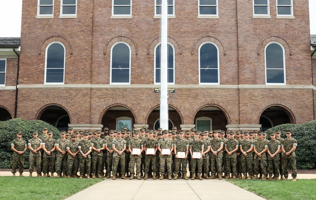 U.S. Marines with 1st Platoon, Guard Company, Marine Barracks Washington, D.C., pose for a group photo at Marine Barracks Washington, D.C., Sept. 3, 2026. The platoon gathered to recognize Marines who were awarded the Navy and Marine Corps Achievement Medal for their decisive actions as part of a reaction team that safely neutralized an armed threat on the installation. (U.S. Marine Corps photo by Cpl. Brynn L. Bouchard)