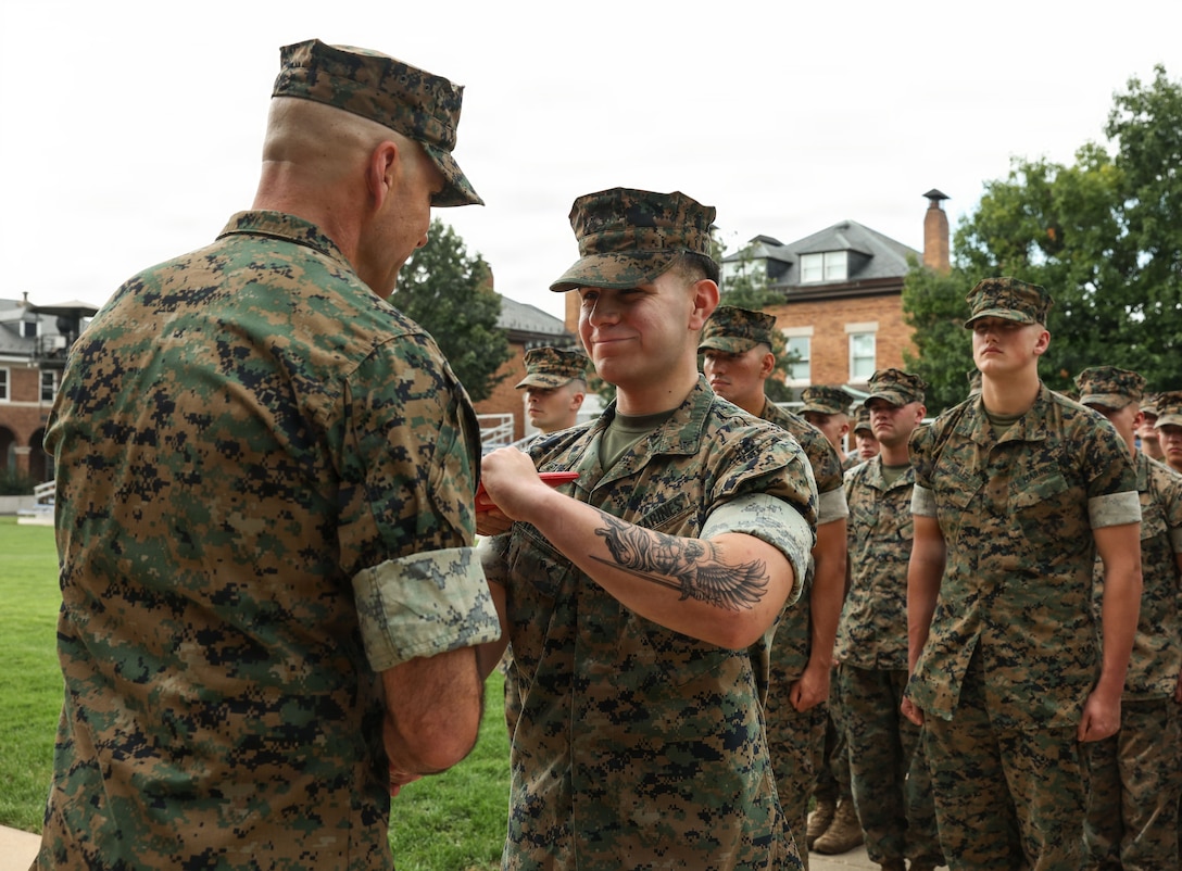 U.S. Marine Corps Lance Cpl. Anthony Verastegui, a rifleman with Guard Company, Marine Barracks Washington, shakes hands with Col. Jason Copeland, commanding officer of Marine Barracks Washington, left, after receiving the Navy and Marine Corps Achievement Medal during an award ceremony at Marine Barracks Washington D.C., Sept. 3, 2026. Verastegui was awarded for his decisive actions as part of a reaction team that safely neutralized an armed threat on the installation. (U.S. Marine Corps photo by Cpl. Brynn L. Bouchard)