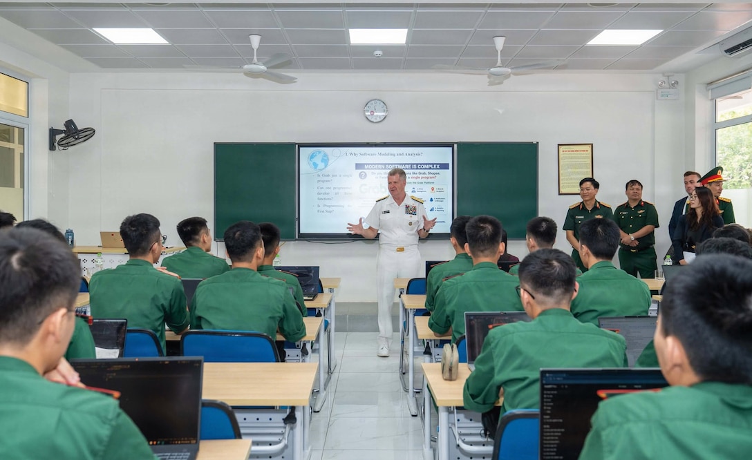 Military employee speaking to students in a classroom.