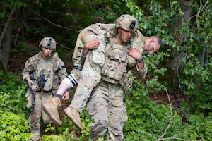U.S. Soldiers assigned to the 173rd Mobile Brigade Combat Team (Airborne) transport a simulated casualty during exercise Saber Junction 26 at the Joint Multinational Readiness Center's Hohenfels Training Area, Germany, Aug. 30, 2026. The 7th Army Training Command provides a unique environment in Europe to develop leaders and formations that are prepared for large-scale combat operations, improving readiness. (U.S. Army photo by Spc. Danil Pak)