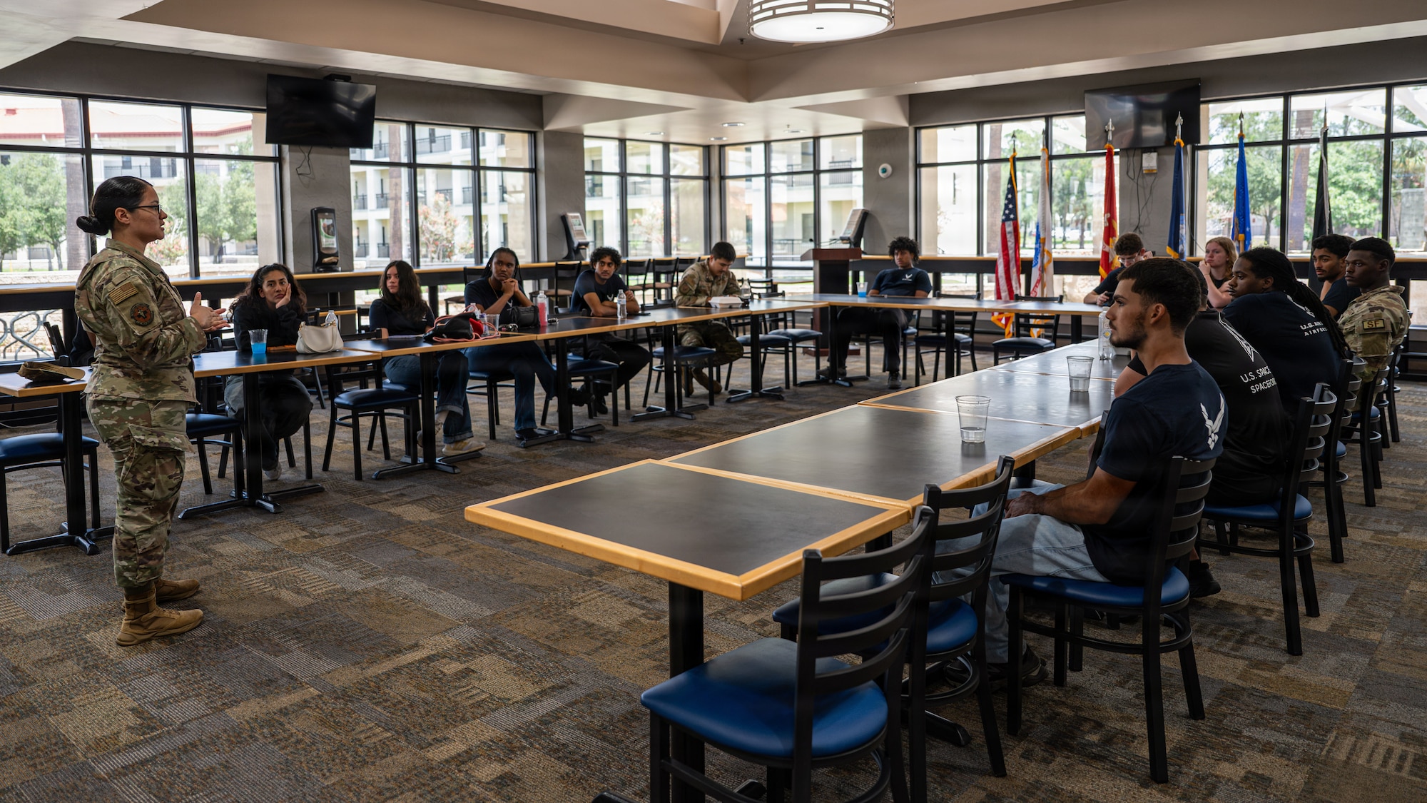 U.S. Air Force Airman 1st Class Caleen Gomez, Junior Enlisted Council professional development coordinator co-chair, briefs delayed entry program participants at MacDill Air Force Base, Florida, Aug. 7, 2026. DEP participants toured MacDill AFB to learn about various Air Force career fields and gain firsthand insight into what to expect as future Airmen. (U.S. Air Force photo by Airman 1st Class Helen Ly)