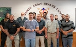 Members of Kenner Army Health Clinic’s Information Management Division (IMD) pose with the Defense Health Agency Auditability Compliance Award at Fort Lee,
