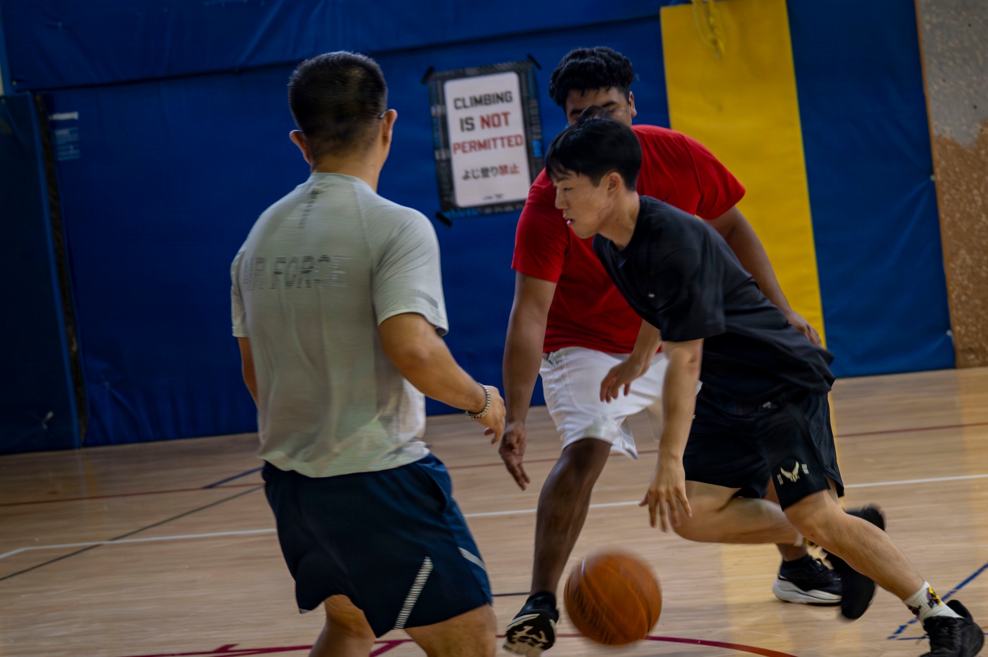 A 35th Fighter Wing Airman drives past defenders while playing basketball during Wing Sports Day at Misawa Air Base, Japan, Sept. 3, 2026.