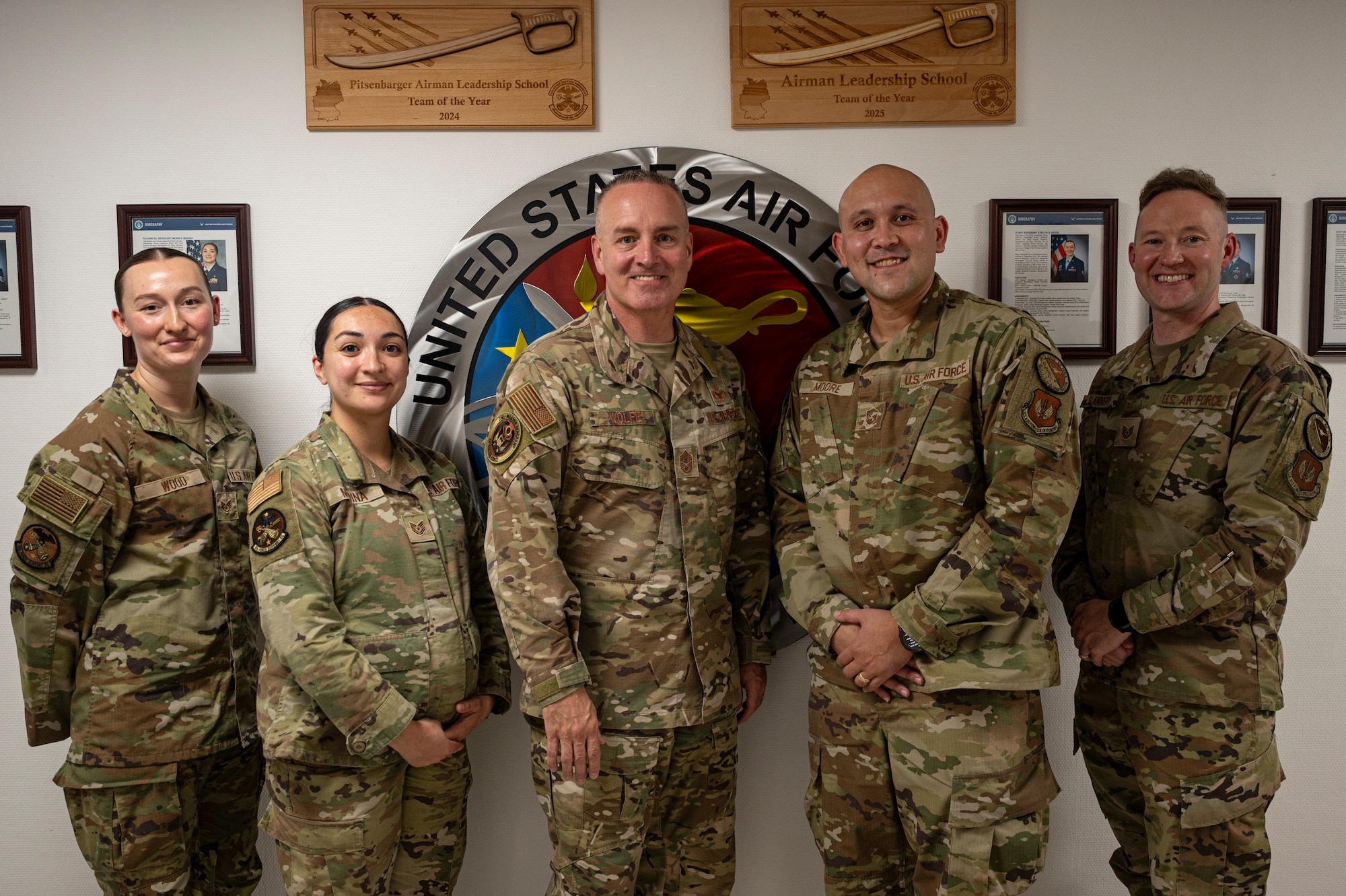 Chief Master Sergeant of the Air Force David Wolfe, center, poses for a photo with the Pitsenbarger Airman Leadership School team, during a base visit.
