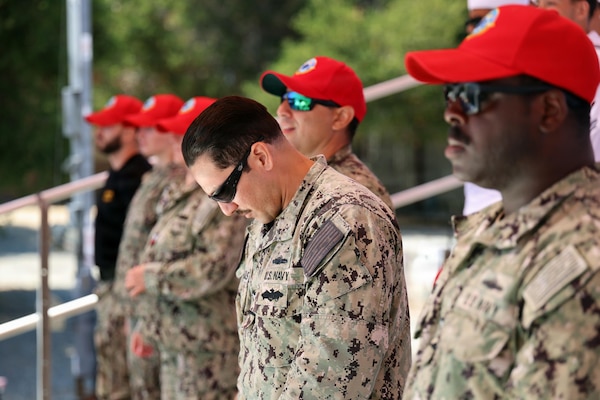 A Sailor assigned to the Naval Expeditionary Medicine Warfighter Development Center bows his head alongside the NEMWDC crew as the benediction begins at the conclusion of the change of command ceremony aboard Marine Corps Base Camp Pendleton, California, Sept. 3, 2026. The traditional invocation marked the official conclusion of the event, as Capt. George Brand assumed responsibility for leading Navy Medicine’s premier Expeditionary Medicine training center.  (U.S. Navy photo by Arsenio R. Cortez Jr.)