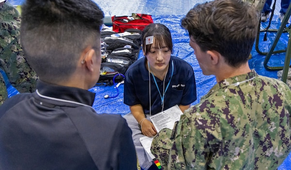 ATSUGI, Japan (Sept. 1, 2026) — Hospital Corpsman Apprentice Isaac Olivea, from U.S. Navy Medicine Readiness and Training Unit (USNMRTU) Atsugi and Dr. Hajime Nakajima, a Japanese Fellow assigned to U.S. Navy Medicine Readiness and Training Command (USNMRTC) Yokosuka treat a simulated casualty during Big Rescue Kanagawa 2026 at the Kanagawa Prefectural Comprehensive Disaster Prevention Center and Fire Academy. Big Rescue Kanagawa is a large-scale, multi-agency disaster-response exercise jointly organized by Kanagawa Prefecture and Atsugi City to rehearse patient reception, bilateral triage, and emergency response operations. (U.S. Navy photo by Daniel Taylor/USNMRTC Yokosuka Public Affairs)