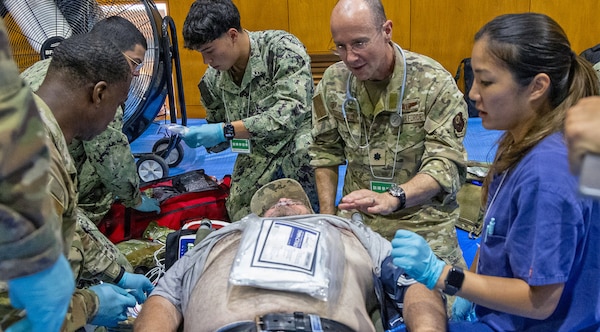 ATSUGI, Japan (Sept. 1, 2026) — A U.S. Air Force medical officer, center right, works alongside U.S. Navy Sailors to provide care during Big Rescue Kanagawa 2026 at the Kanagawa Prefectural Comprehensive Disaster Prevention Center and Fire Academy. Big Rescue Kanagawa is a large-scale, multi-agency disaster-response exercise jointly organized by Kanagawa Prefecture and Atsugi City to rehearse patient reception, bilateral triage, and emergency response operations. (U.S. Navy photo by Daniel Taylor/USNMRTC Yokosuka Public Affairs)