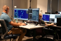 men work on computers
