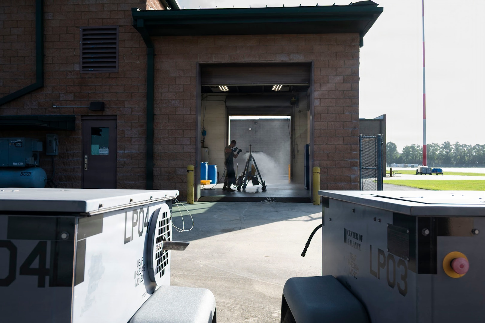 U.S. Air Force Tech. Sgt. Levi Luciani, an aerospace ground equipment specialist assigned to the 165th Maintenance Squadron, 165th Airlift Wing, Georgia Air National Guard, washes a maintenance stand after an inspection, July 20, 2026 at the Savannah Air National Guard Base, Georgia.Inspections of aerospace ground equipment help ensure maintainers have safe, serviceable equipment to perform aircraft maintenance while supporting the wing's operational readiness. (U.S. Air National Guard photo by Senior Airman Selena Acosta)