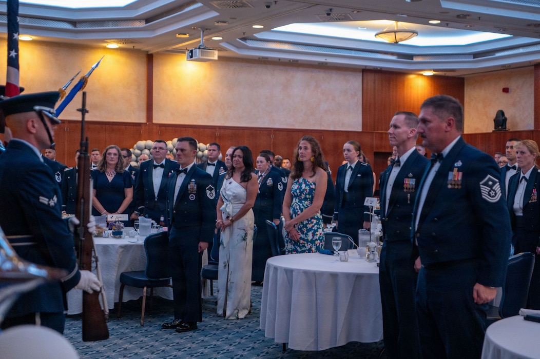 People stand at a ceremony