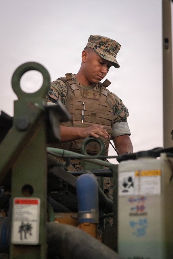 A U.S. Marine with 4th Light Armored Reconnaissance Battalion, 4th Marine Division, performs maintenance on a medium tactical vehicle replacement during a Reserve Mobilization Exercise, Marine Corps Base Camp Pendleton, California, July 15, 2026. The week-long exercise validates the battalion’s ability to rapidly activate personnel and equipment, ensuring the unit can deliver ready forces in response to a national crisis. (U.S. Marine Corps photo by Lance Cpl. Claire Cheney)