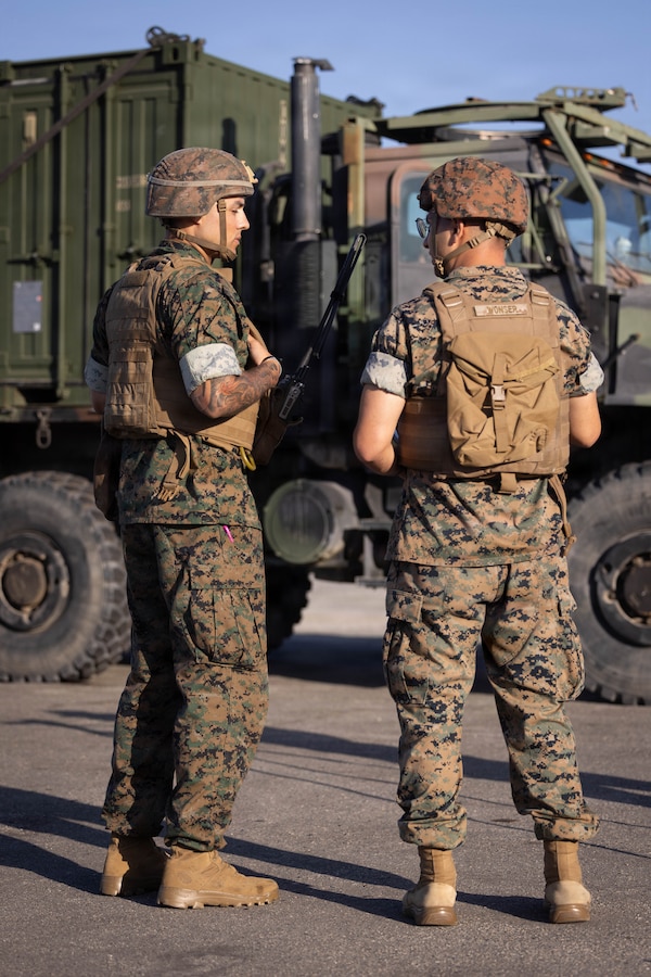 U.S. Marines with 4th Light Armored Reconnaissance Battalion, 4th Marine Division, speak to one another during a Reserve Mobilization Exercise, Marine Corps Base Camp Pendleton, California, July 15, 2026. The week-long exercise validates the battalion’s ability to rapidly activate personnel and equipment, ensuring the unit can deliver ready forces in response to a national crisis. (U.S. Marine Corps photo by Lance Cpl. Claire Cheney)