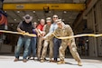 CAMP PENDLETON, Calif. — Maj. Gen. Windsor S. Buzza, commanding general of the 63d Readiness Division, center, and Maj. Matthew McDaniel, 63d RD Directorate of Public Works, right, join Army Reserve personnel and project stakeholders during a ribbon-cutting ceremony for the new Area Maintenance Support Activity 29 facility at Camp Pendleton, California. The new facility expands maintenance capability for Army Reserve units throughout the greater San Diego area. (U.S. Army Reserve photo by Master Sgt. Christopher A. Oposnow)