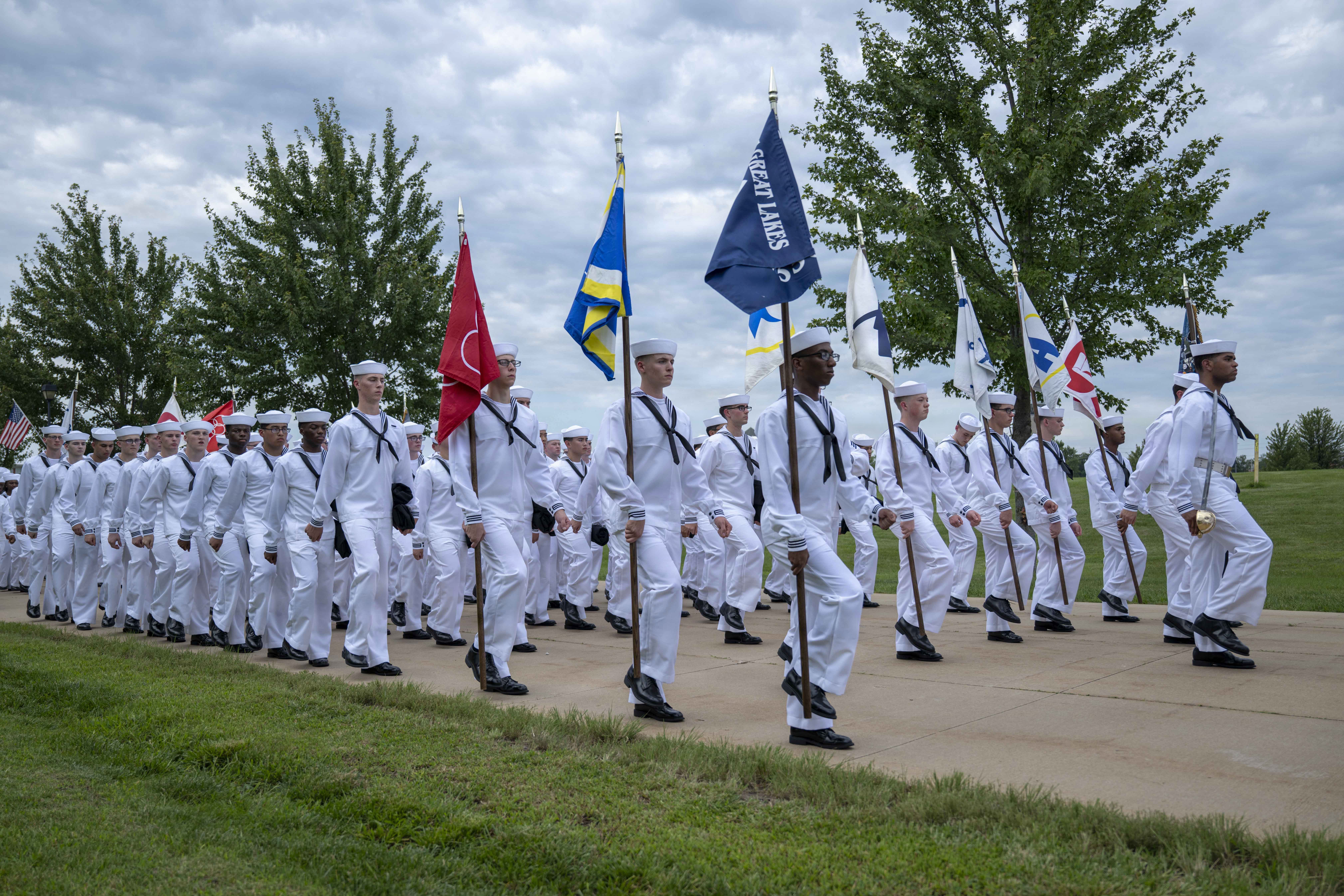 Sailors wait to march into Midway Ceremonial Drill Hall during pass-in-review onboard U.S. Navy Recruit Training Command. Training is approximately nine weeks and all enlistees in the U.S. Navy begin their career at the command. More than 40,000 recruits train annually at the Navy’s only boot camp.
