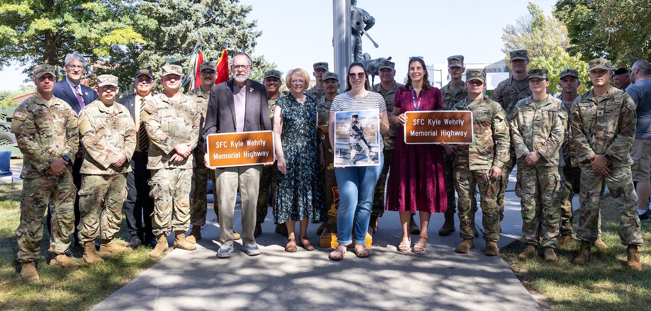 Illinois Army National Guard Soldiers serving in Battery B, 2nd Battalion, 123rd Field Artillery Regiment, shown with Sgt. 1st Class Kyle Wehrly’s family, were in attendance during the highway dedication ceremony honoring Wehrly Sept. 4 in Galesburg.