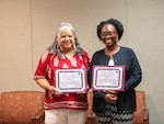 Melanie Stewart, left, and Corretta Custis, right, display their People’s Choice Awards at Kenner Army Health Clinic. Both were recognized for their efforts to improve care coordination and access to patient care.