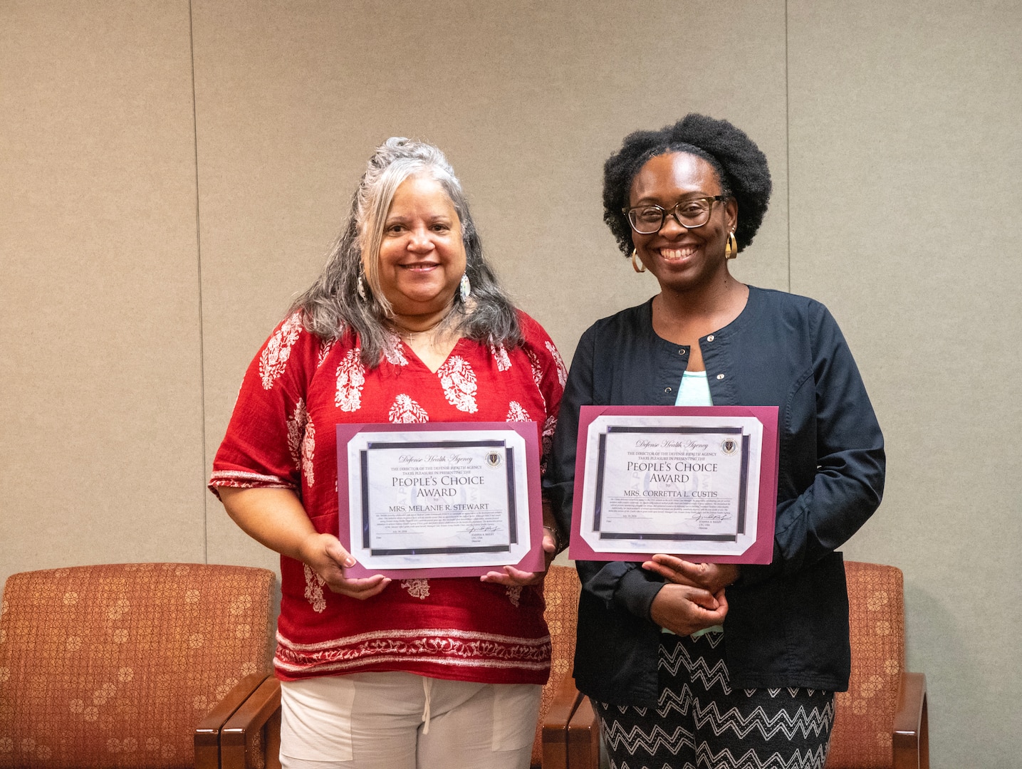 Melanie Stewart, left, and Corretta Custis, right, display their People’s Choice Awards at Kenner Army Health Clinic. Both were recognized for their efforts to improve care coordination and access to patient care.