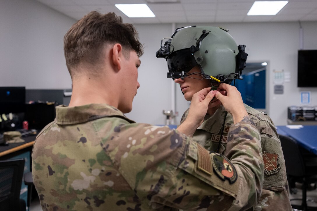 Guy gets fitted for a helmet.