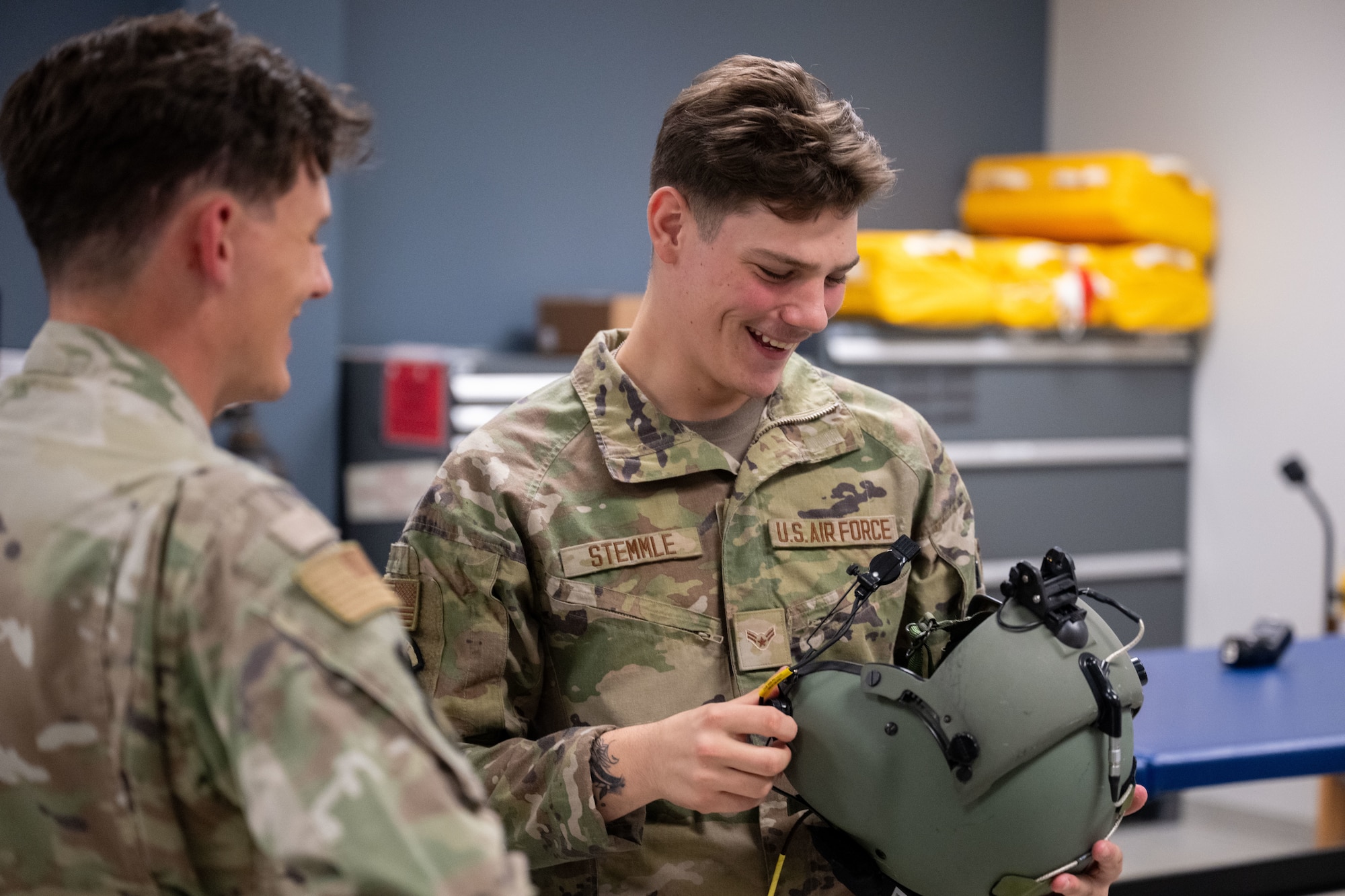 Guy holds a helmet.