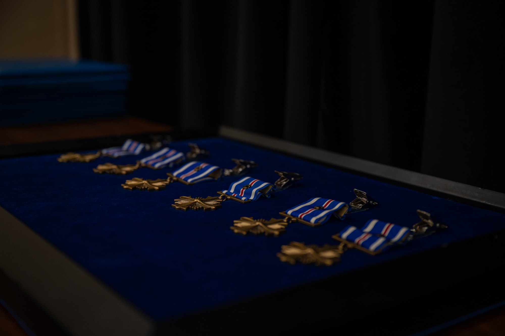 LANGLEY AIR FORCE BASE, Va – Distinguished Flying Cross medals with the “C” device wait to be presented during a Distinguished Flying Cross ceremony at Langley Air Force Base, Virginia, Aug. 31, 2026. The DFC medal with the “C” device is awarded to Airmen who were exposed to hostile action and had shown heroism or extraordinary achievement while participating in aerial flight. (U.S. Air Force photo by Airman 1st Class Kaden Ciminnisi)